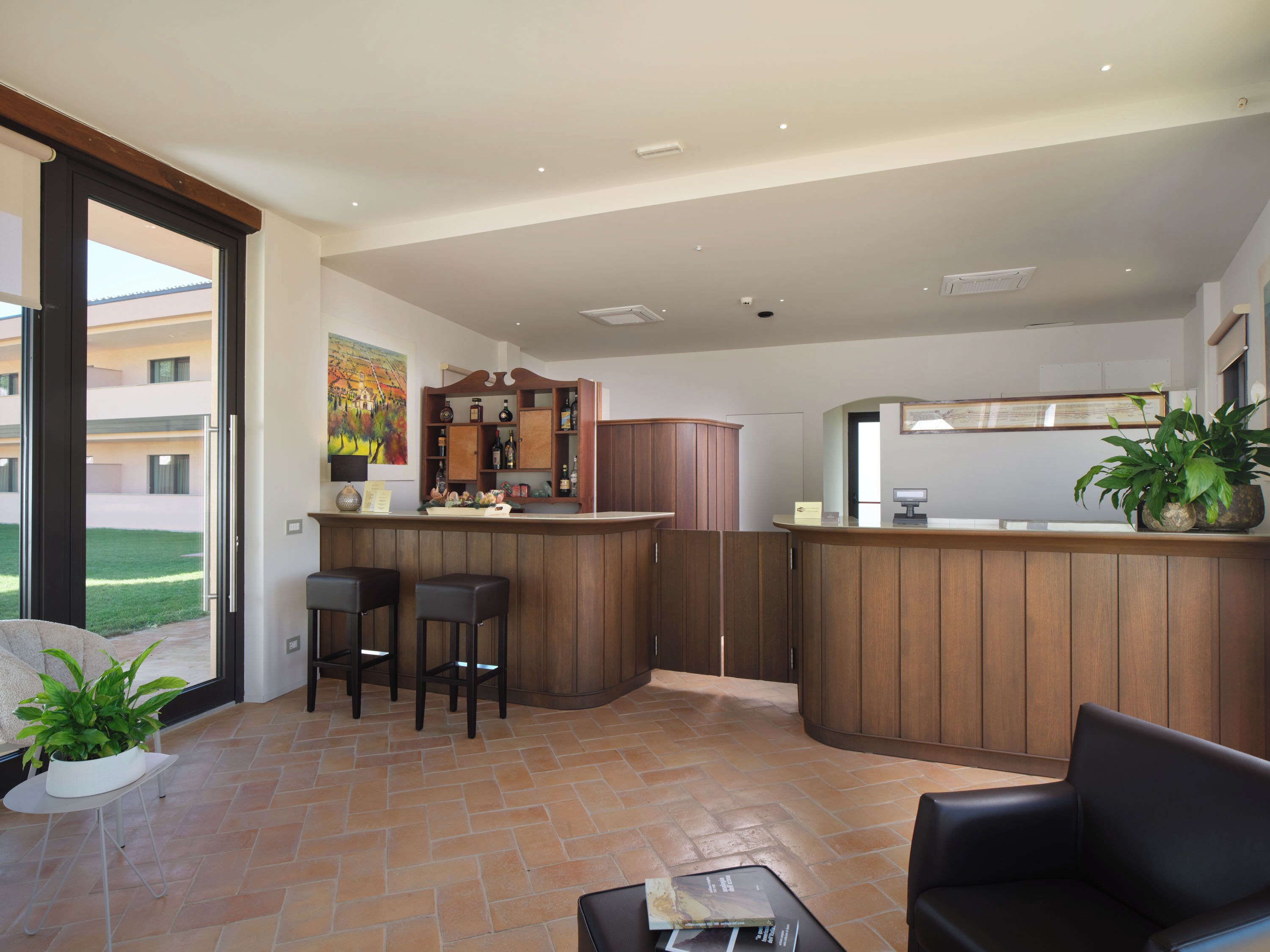 A modern kitchen with a bar area, two bar stools, and a dining table with chairs.