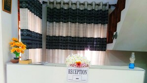 A reception desk with a sign that reads "RECEPTION OPEN". - Greenwood Udawalawa safari resort (Udawalawa)