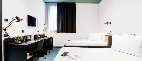 A modern hotel room with a desk, two beds, a TV, and a window with curtains.