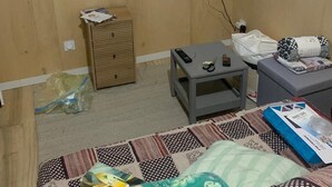 A hotel room with a bed, a small table, a television mounted on the wall, and a wooden cabinet. - Garden studio in the Normandy countryside, near the D-Day landing beaches. (RYES)