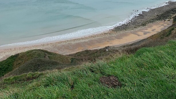 A coastal landscape with a grassy foreground leading to a sandy beach and the ocean. - Garden studio in the Normandy countryside, near the D-Day landing beaches. (RYES)