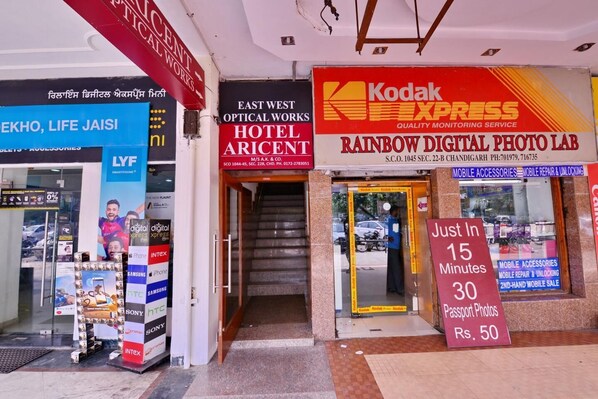 A storefront with a Kodak Express sign, a hotel sign, and a digital photo lab.