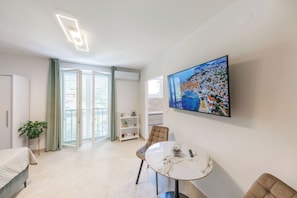 Apartment (0 Bedroom) | Living area | 123-cm TV with satellite channels