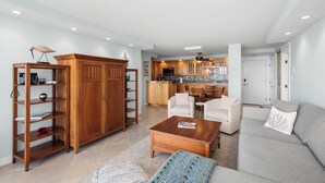 A spacious living room with a wooden bookshelf, a coffee table, and a sofa.