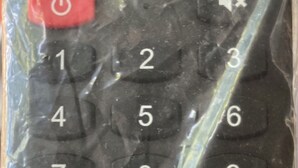 A remote control with buttons labeled for Netflix, YouTube, and Google Play.