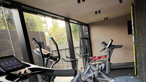 A gym with treadmills, elliptical machines, and weight equipment. - Chic studio with WiFi and AC in serene Nairobi (Nairobi)