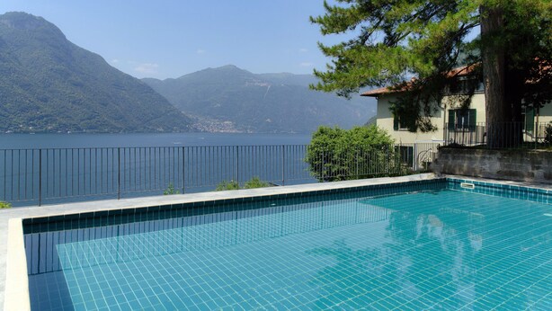Une piscine avec vue sur un lac et des montagnes.