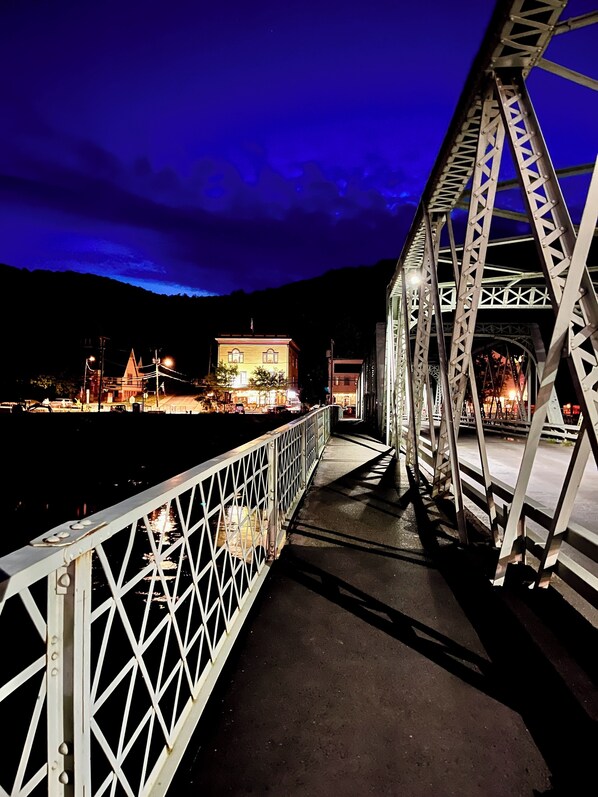 A metal bridge with a pedestrian walkway and railings.