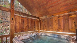 A wooden cabin with a hot tub.