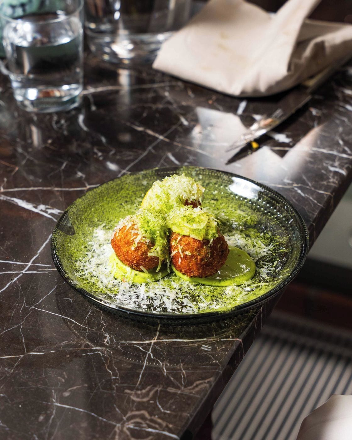 A plate of food on a dark marble countertop.