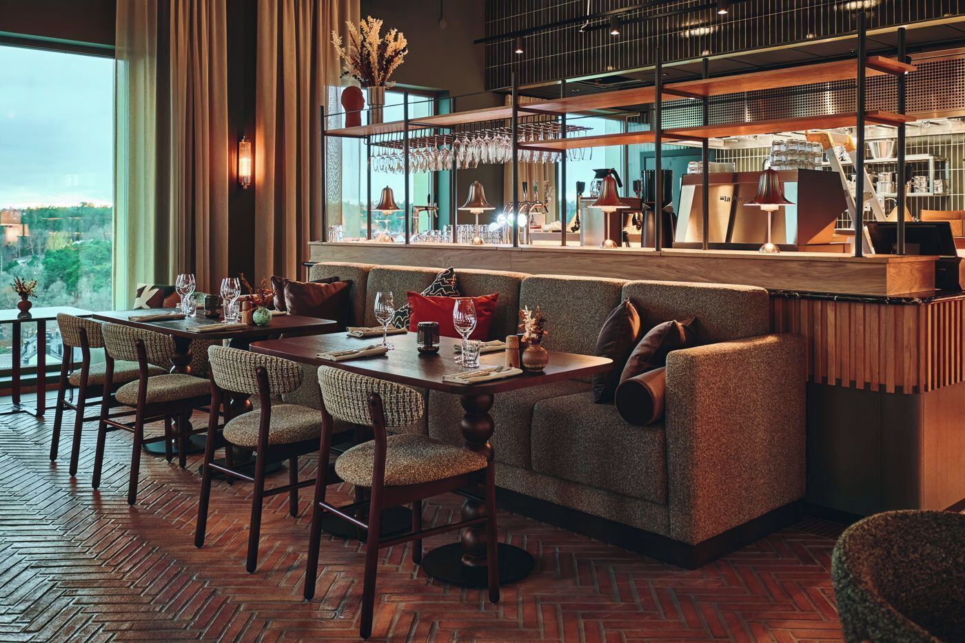 A modern dining area with a wooden table, upholstered chairs, and a cushioned bench.