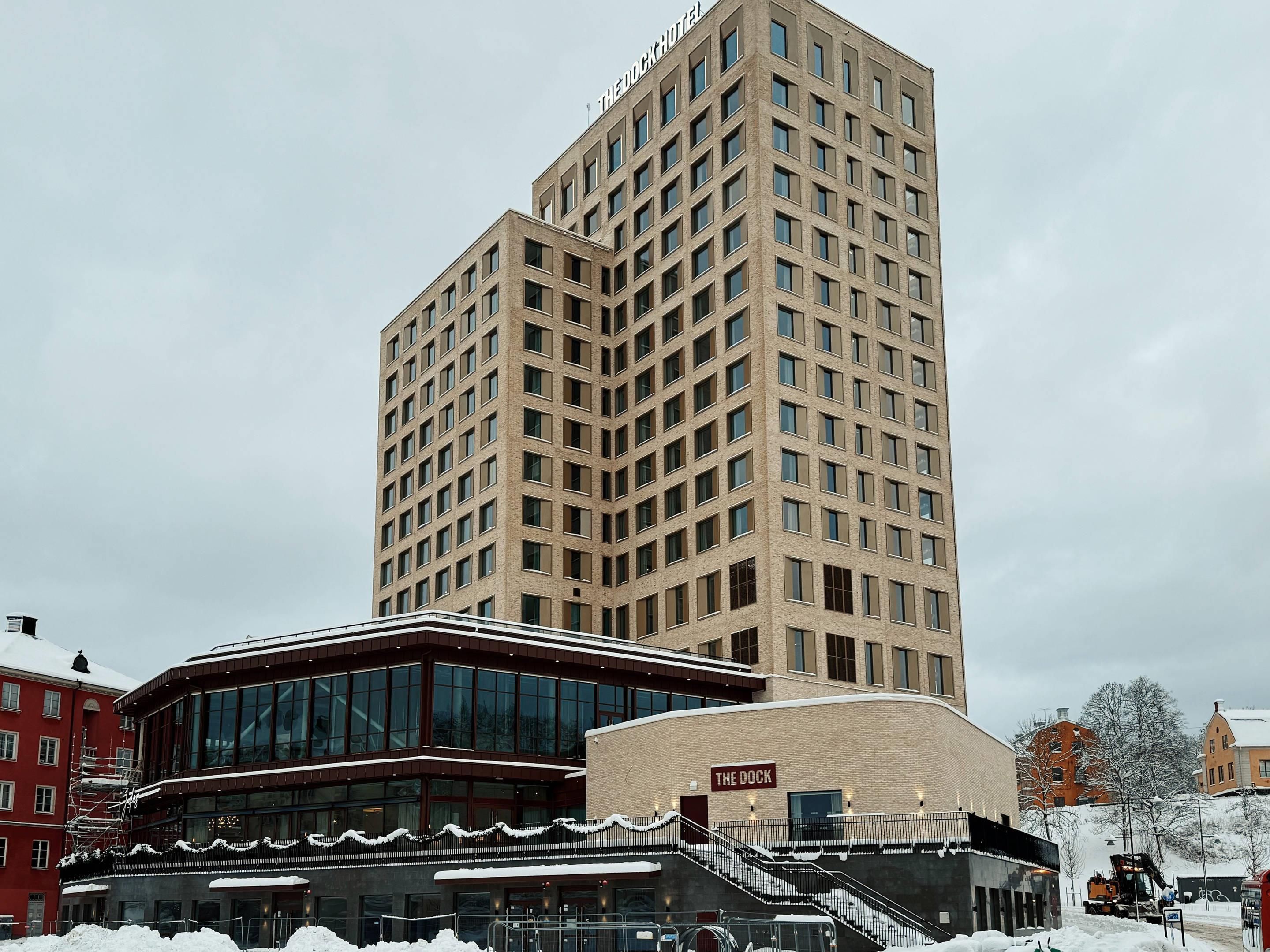 A multi-story hotel with a modern design, featuring a prominent staircase leading to the entrance.