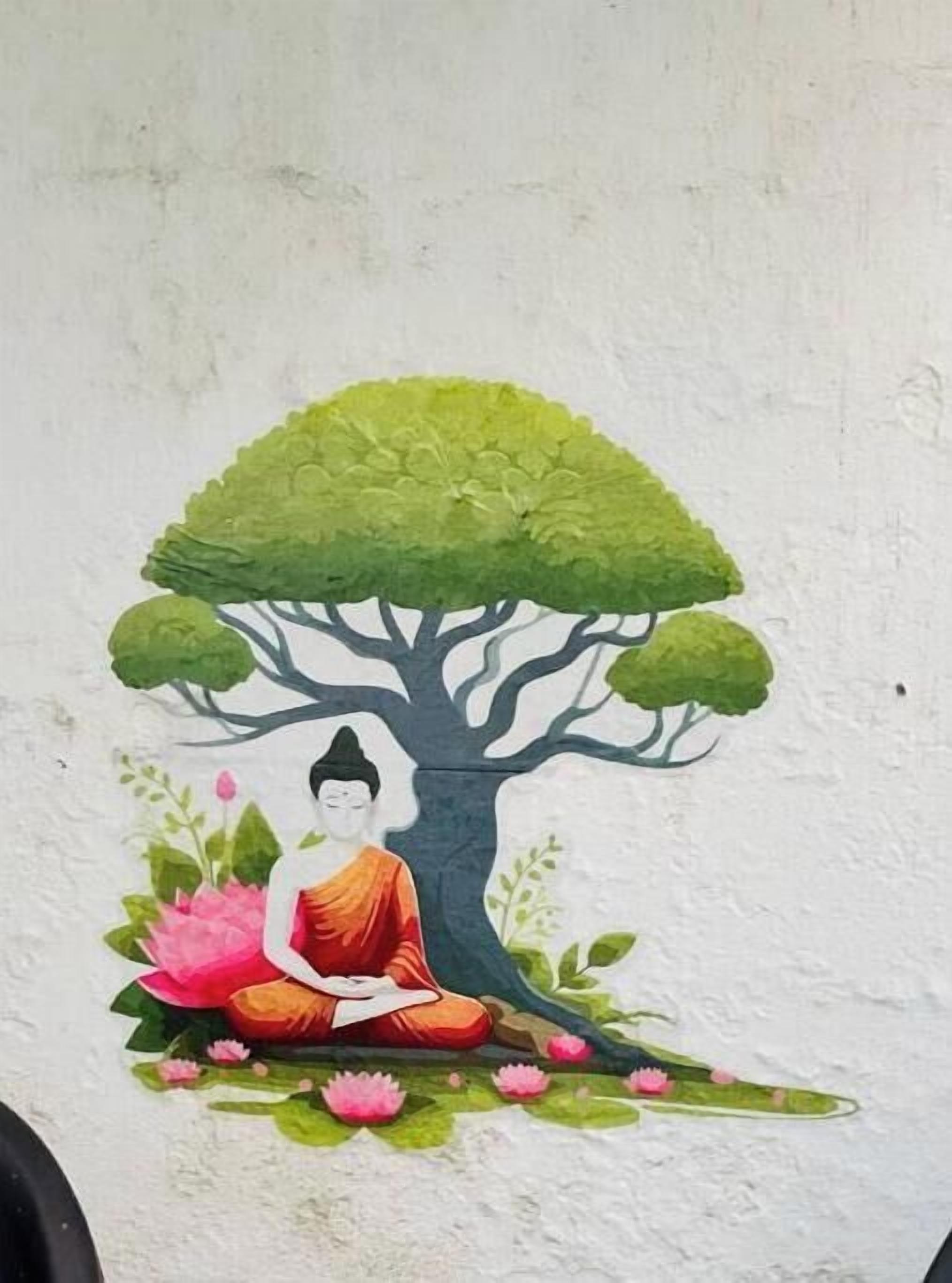 A mural of a seated figure under a tree with lotus flowers.
