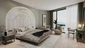 A modern bedroom with a large bed, a desk, and a view of the city. - Qlusive Hotel (Kusadasi)