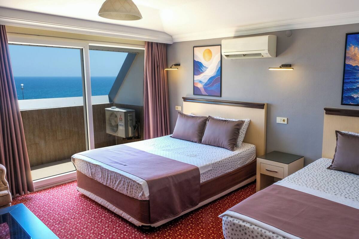 Habitación triple clásica, balcón, vista al mar | Minibar, escritorio, espacio para trabajar con laptop y insonorización