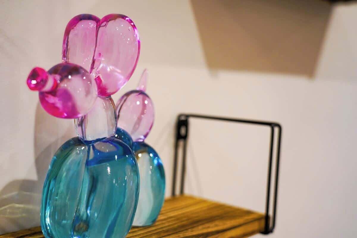 A glass sculpture on a wooden surface.