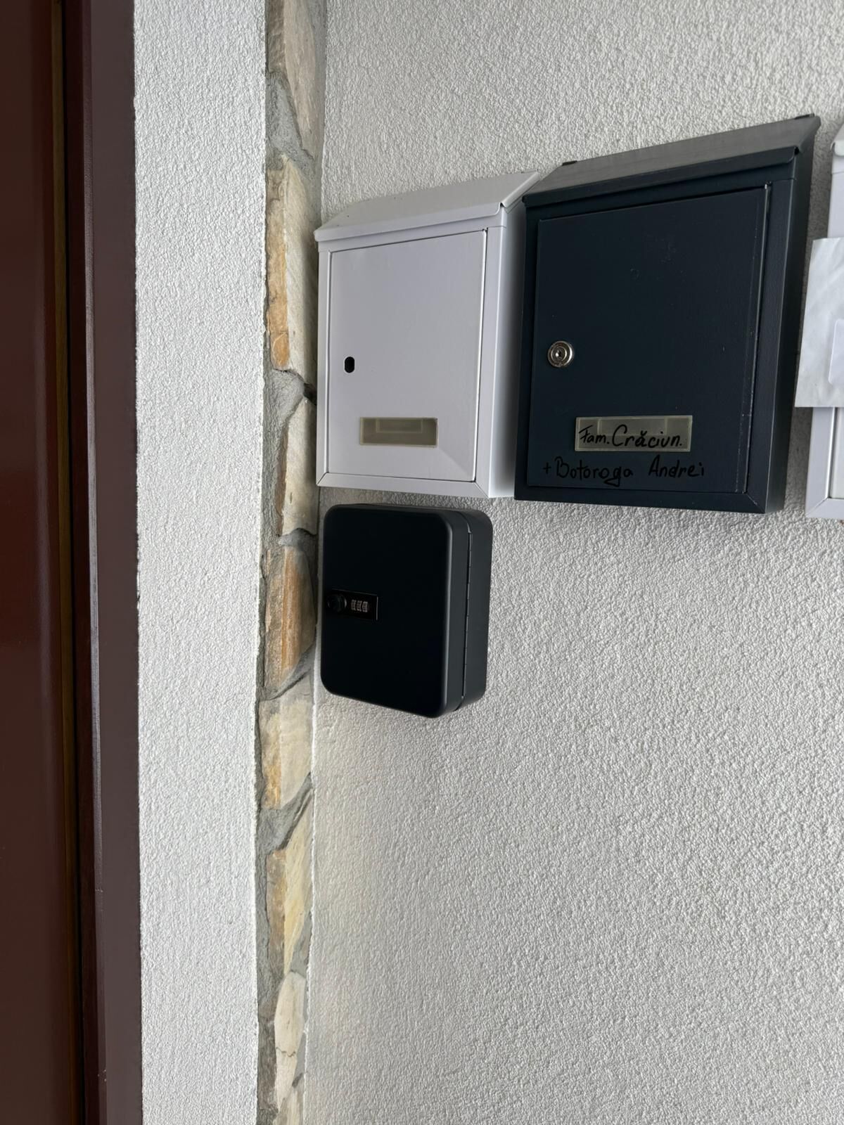 A wall-mounted intercom system with a nameplate reading "Fam. Craciuin" and "Dotoroga Andrei".