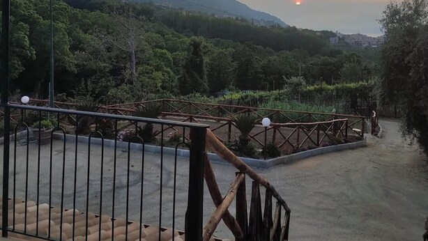A staircase leading to a balcony with a view of a mountainous landscape and a sunset. - Nature room, double room with private bath 20 Min from Pompeii, 40 from amalfi (Campania)