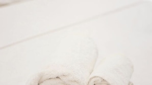 A neatly folded white towel on a white surface. - Estia apartment (Athina)