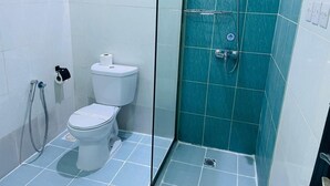 A bathroom with a toilet, a shower, and a window. - Doolve Riyadh 1 (Riyadh)