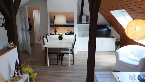 A modern interior with a dining area, kitchen, and seating space. - Holiday Apartment 'Ferienwohnung Rathjen' with Private Terrace, Shared Garden and Wi-Fi (Cuxhaven)
