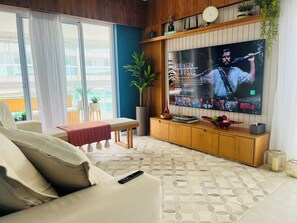 Deluxe Apartment | Living room | 70-inch Smart TV with digital channels, Netflix, streaming services