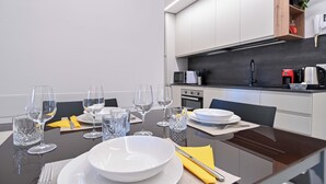 A modern kitchen with white cabinets, a black countertop, and a microwave. - [10min BGY Airport] Bilo Chic: garage + A/C (Seriate)