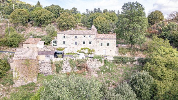 A stone building with a tiled roof, surrounded by greenery and trees. - Holiday Home 'La Casita' with Mountain View, Private Terrace (Beauvène)