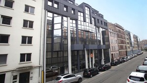 A multi-story building with large windows and a modern facade. - T2 charmant en centre-ville, près des commerces (Strasbourg)