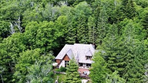 A house surrounded by dense forest. - Foxwood at Snowshoe Mountain (Snowshoe)