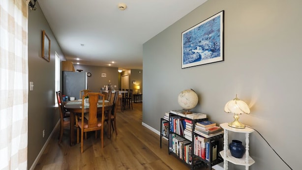 A dining area with wooden chairs and a table, a bookshelf with books and a globe, and a painting on the wall. - Quiet, Family Friendly 3/2 Home (Columbia)