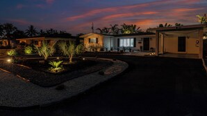 A residential property with a driveway, landscaped garden, and a garage.