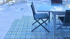 An outdoor patio with a glass table and chairs, a small playhouse, and a view of a forested hillside. - Ground floor, terrace, tv, 193m², Vars (Vars)