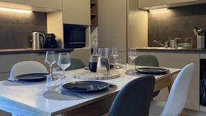 A modern dining area with a long table set for four, equipped with plates, glasses, and cutlery. - Ground floor, terrace, tv, 193m², Vars (Vars)