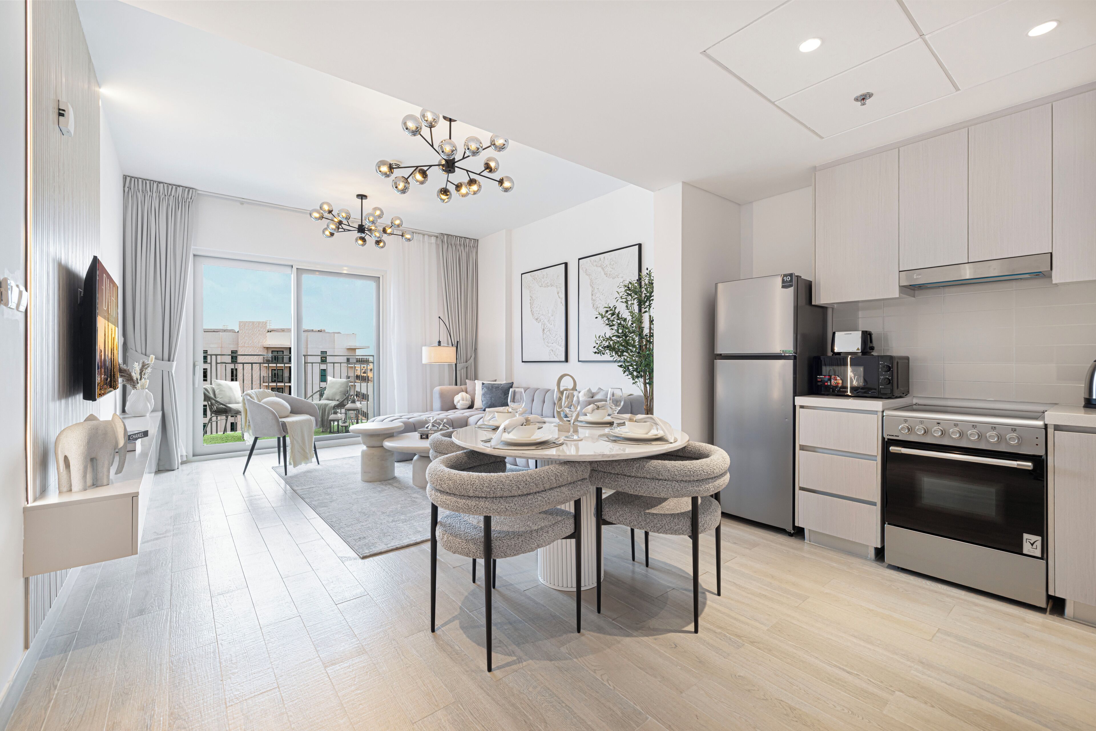 A modern kitchen with a built-in oven, a refrigerator, and a microwave.