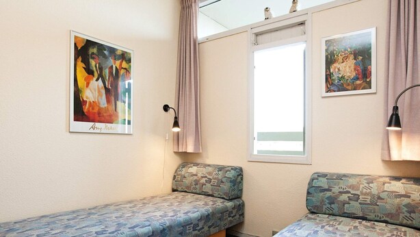 A room with two beds, a window, and two paintings on the walls. - 4 Person Holiday Home on a Holiday Park in Fano (Fano)