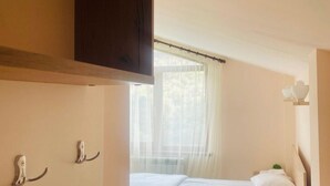 A bedroom with a bed, a window with sheer curtains, and a wooden headboard. - Lovely 5-bedroom house with WiFi in charming Dilijan (Dilijan)