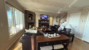 A living room with a fireplace, a television, a sofa, and a coffee table.