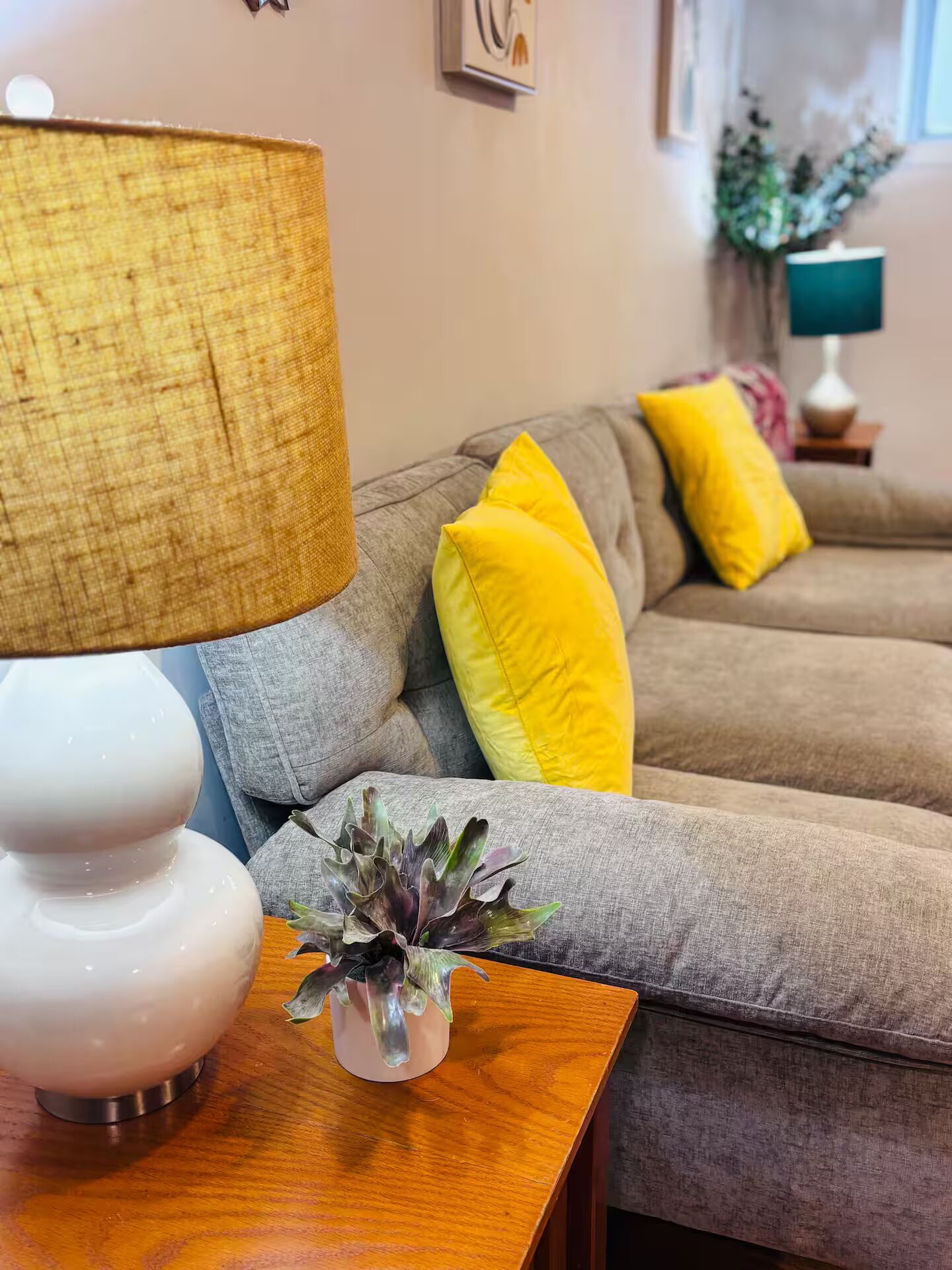 Living room downstairs is bright and colorful. Comfy for your stay!