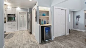 A modern kitchen with white cabinetry, an oven, and a dishwasher.