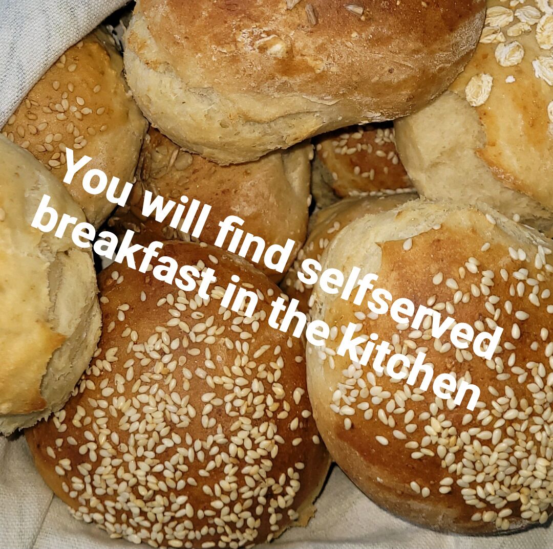 A collection of self-served breakfast rolls with sesame seeds.