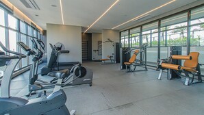 A modern gym with various exercise equipment, large windows, and a clean, spacious layout. - Functional Near Allianz Parque Sp-p1303a (São Paulo)
