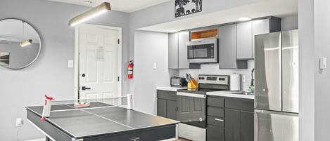 Una cocina moderna con microondas integrado, horno y refrigerador de acero inoxidable.