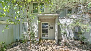 A house with a front porch, a small garden area with a pathway, and a wooden fence. - Pool, Hot Tub & Fitness Center! Gem By Lake DeSoto (Hot Springs)