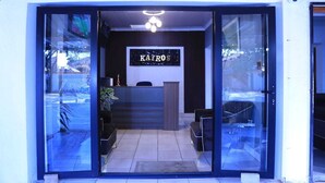 A reception area with a sign reading "KAJROS" and a modern interior design. - 12-bedroom bed guest house in charming Bedfordvew with WiFi, AC (Germiston)