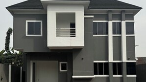 A modern two-story house with a flat roof, large windows, and a small balcony. - COZY 4-BRM fully detached Duplex with PS5, STARLINK Wifi in Port Harcourt (Port Harcourt)