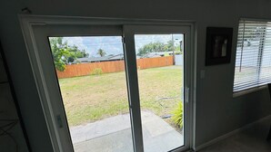 A room with a sliding glass door leading to a backyard. - Entire place in the heart of Sarasota (Sarasota)