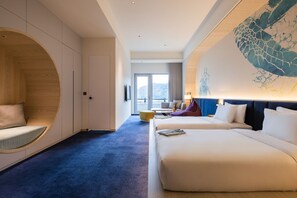 A hotel room with a large bed, a seating area with a curved wooden design, and a view of a snowy landscape through the window. - The Archipelago (Yilan County)