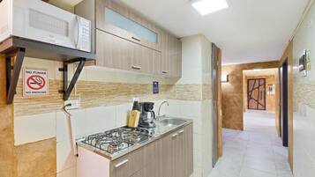 Fridge, microwave, stovetop, coffee/tea maker