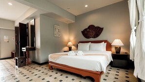 A hotel room with a bed, two bedside tables with lamps, a wall decoration, and a tiled floor. - Lanna Oriental Mae Rim (Mae Rim)